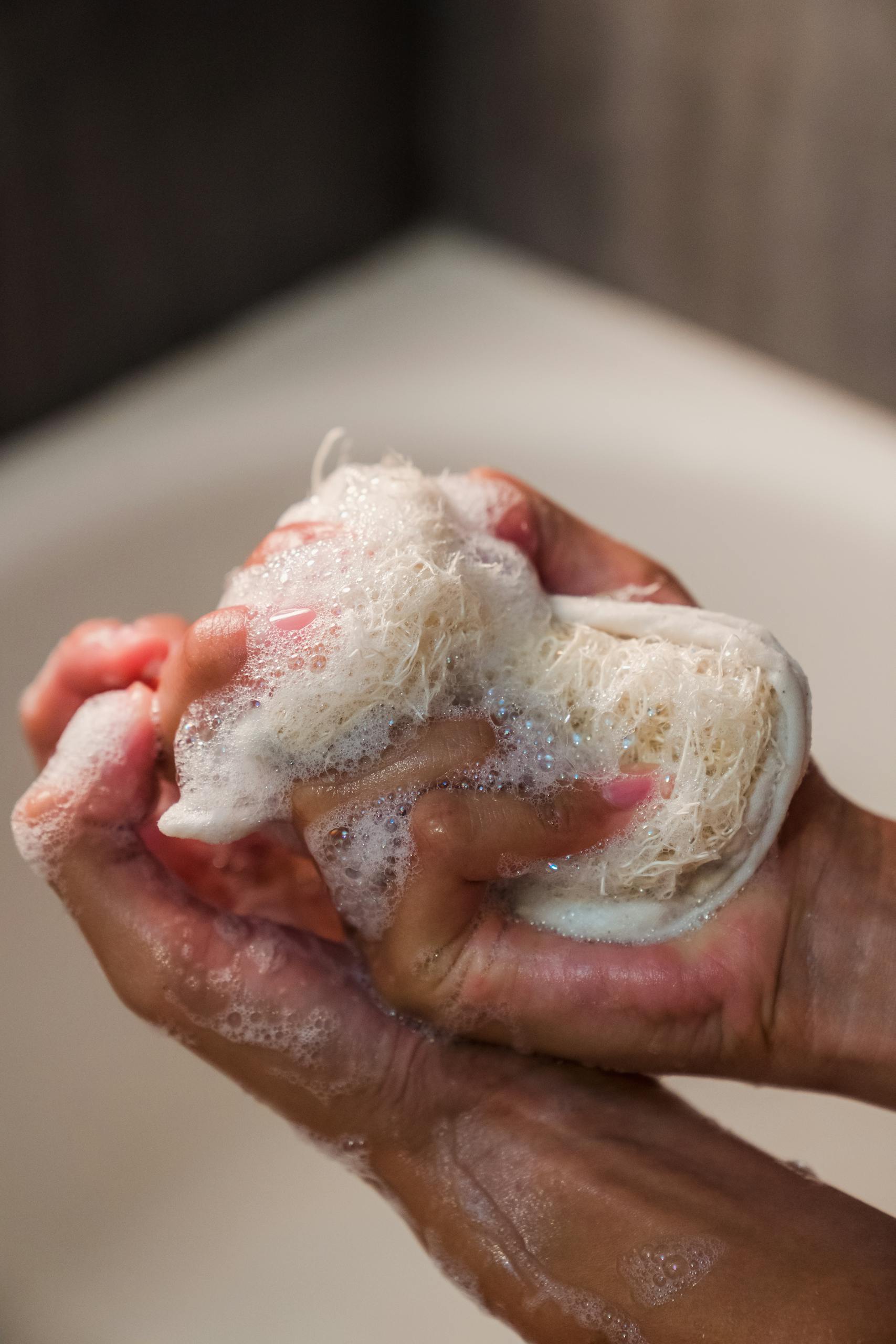 Close-Up Photo of a Person Using a Body Scrub